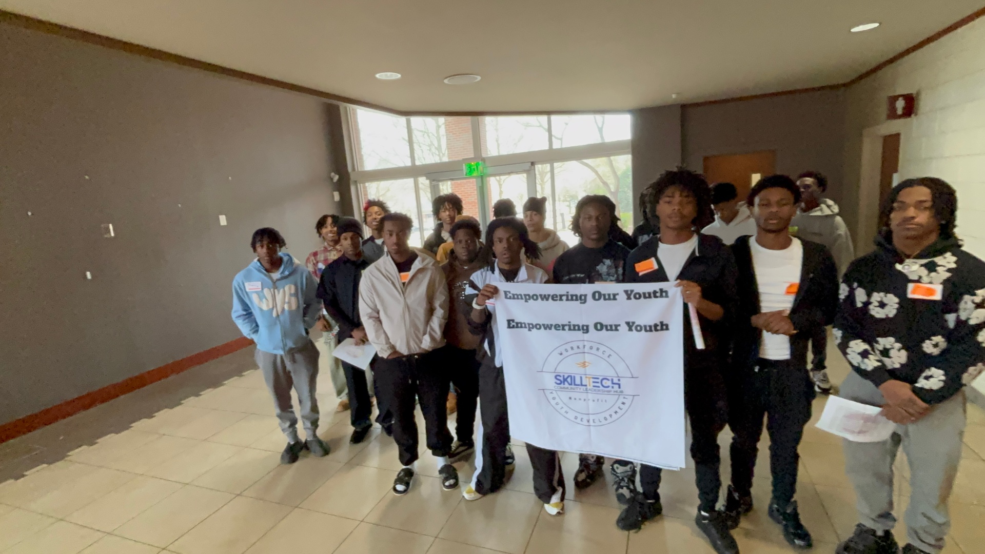 Students with Empowering Our Youth banner